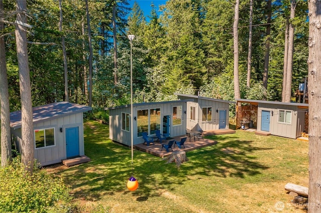 64 Eliza Is, Bellingham, WA 98226 - back of house featuring a deck, board and batten siding, and a lawn