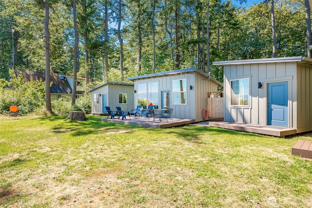64 Eliza Is, Bellingham, WA 98226 - back of house featuring board and batten siding, a wooden deck, and an outdoor structure