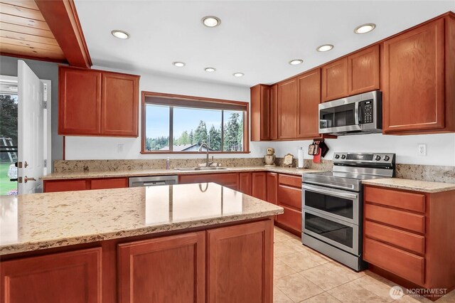 8402 57th Ave E, Puyallup, WA 98371 - kitchen with stainless steel appliances, a sink, light stone counters, recessed lighting, and light tile patterned flooring