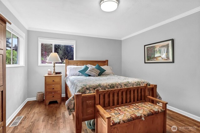 8402 57th Ave E, Puyallup, WA 98371 - bedroom featuring ornamental molding, light wood-style flooring, and baseboards
