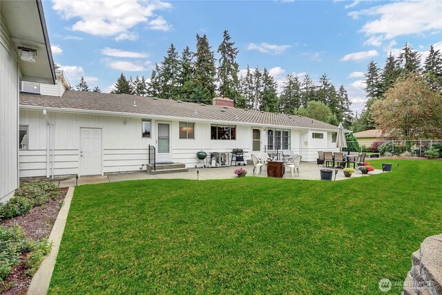 8402 57th Ave E, Puyallup, WA 98371 - rear view of property with entry steps, a patio, a chimney, and board and batten siding