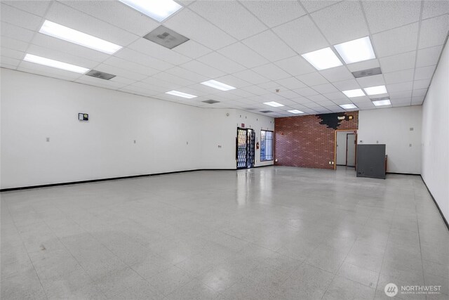 8402 57th Ave E, Puyallup, WA 98371 - unfurnished room featuring a drop ceiling and baseboards
