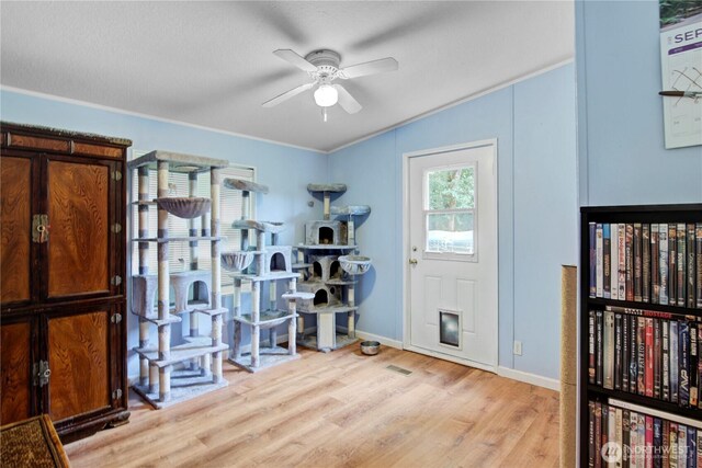 140 Leland Rd, Longview, WA 98632 - exercise room featuring light wood-type flooring, a ceiling fan, baseboards, ornamental molding, and vaulted ceiling