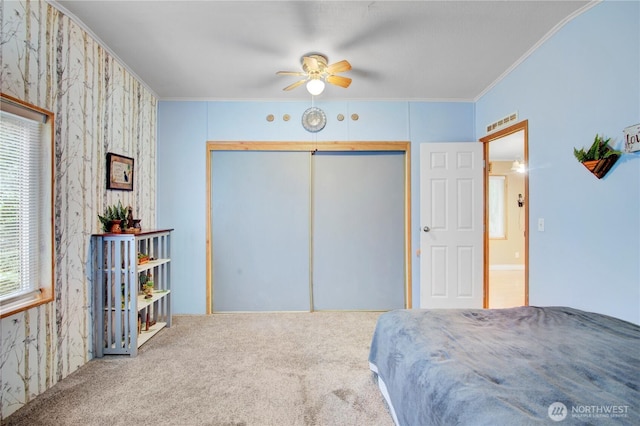 140 Leland Rd, Longview, WA 98632 - bedroom featuring carpet floors, crown molding, a closet, ceiling fan, and wallpapered walls