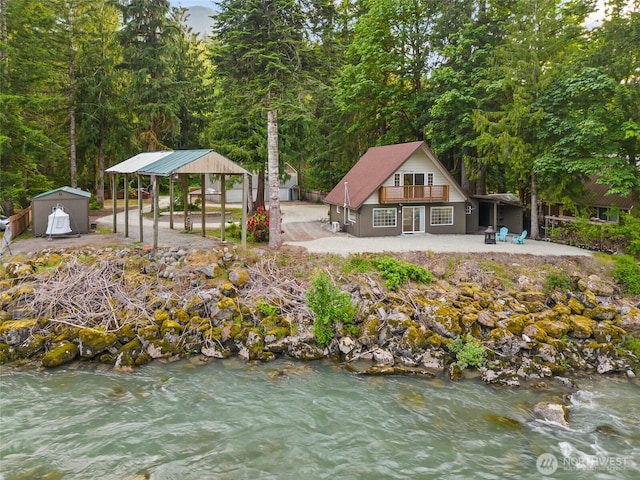 25921 Clear Creek Rd, Darrington, WA 98241 - back of house with a patio, a view of trees, and a carport