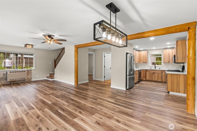 25921 Clear Creek Rd, Darrington, WA 98241 - kitchen with freestanding refrigerator, open floor plan, recessed lighting, wood finished floors, and light countertops