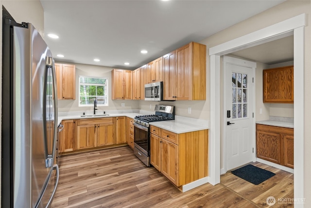 25921 Clear Creek Rd, Darrington, WA 98241 - kitchen with appliances with stainless steel finishes, a sink, light wood-type flooring, light countertops, and recessed lighting