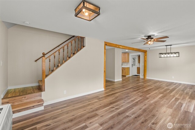25921 Clear Creek Rd, Darrington, WA 98241 - unfurnished living room featuring stairs, wood finished floors, a ceiling fan, and baseboards