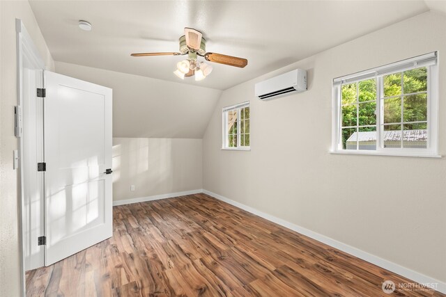 25921 Clear Creek Rd, Darrington, WA 98241 - additional living space featuring a wall mounted air conditioner, lofted ceiling, wood finished floors, baseboards, and a ceiling fan
