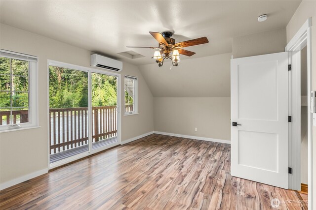 25921 Clear Creek Rd, Darrington, WA 98241 - additional living space with a wall mounted air conditioner, ceiling fan, baseboards, light wood-type flooring, and vaulted ceiling
