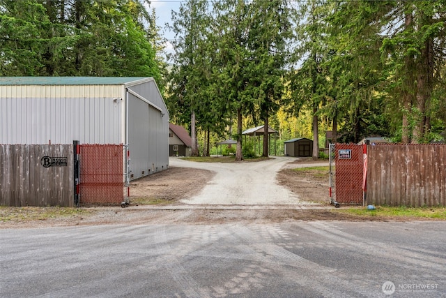 25921 Clear Creek Rd, Darrington, WA 98241 - view of dirt / gravel driveway with view of scattered trees and a gated entry