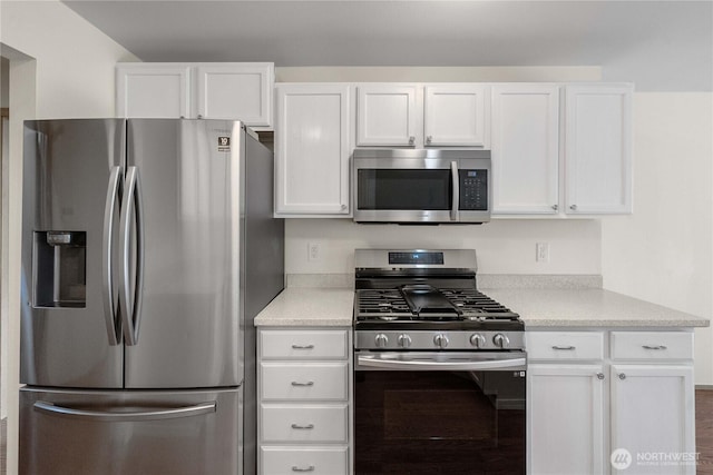 502 NW Alexander Ct, Orting, WA 98360 - kitchen with stainless steel appliances and white cabinets