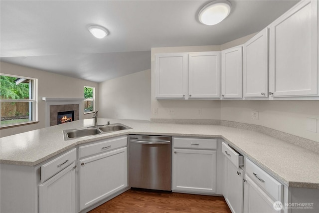 502 NW Alexander Ct, Orting, WA 98360 - kitchen featuring stainless steel dishwasher, a sink, a peninsula, and white cabinetry