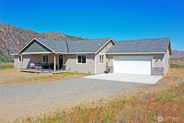 212 Hubbard Rd, Riverside, WA 98849 - ranch-style home featuring driveway, a mountain view, an attached garage, covered porch, and roof with shingles