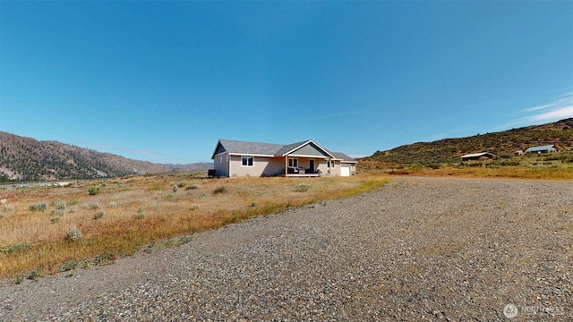 212 Hubbard Rd, Riverside, WA 98849 - ranch-style house with gravel driveway, a mountain view, and a garage