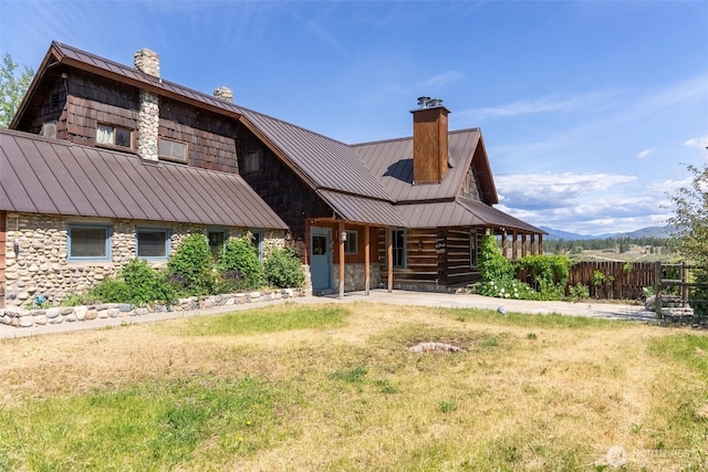 132 Twin Lakes Rd, Winthrop, WA 98862 - rear view of house featuring a standing seam roof, a chimney, and a metal roof