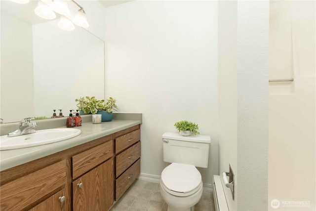 1755 W Sunn Fjord Ln Unit D65, Bremerton, WA 98312 - bathroom featuring a baseboard radiator, toilet, vanity, and baseboards