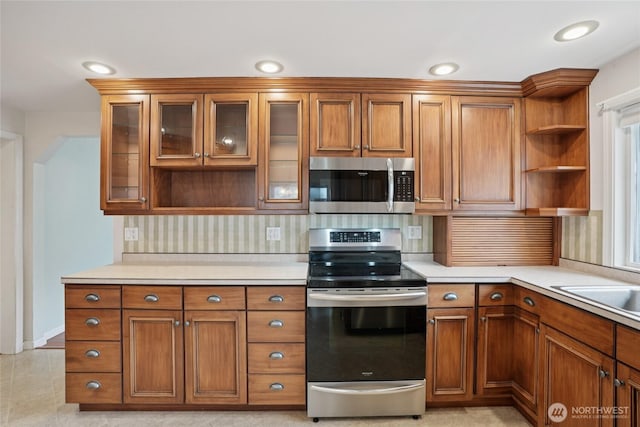 636 20th Ave, Longview, WA 98632 - kitchen featuring stainless steel appliances, open shelves, brown cabinets, light countertops, and recessed lighting