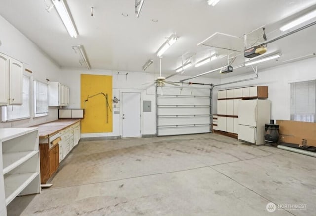 636 20th Ave, Longview, WA 98632 - garage featuring freestanding refrigerator, a garage door opener, and electric panel