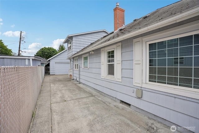 636 20th Ave, Longview, WA 98632 - view of side of property featuring a chimney, an outbuilding, and a garage