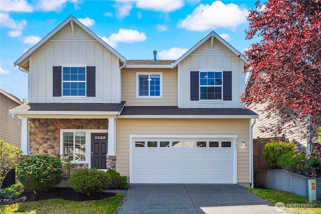 27677 256th Pl SE, Maple Valley, WA 98038 - view of front of property featuring board and batten siding, an attached garage, driveway, and stone siding