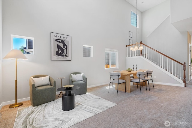 27677 256th Pl SE, Maple Valley, WA 98038 - living area featuring a high ceiling, stairway, carpet floors, and healthy amount of natural light