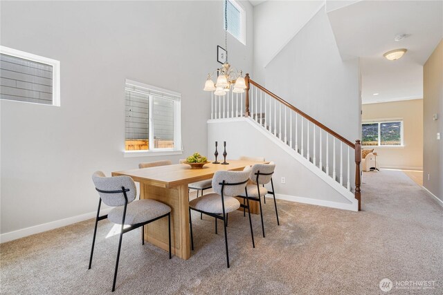 27677 256th Pl SE, Maple Valley, WA 98038 - carpeted dining area featuring a chandelier, stairs, a towering ceiling, and baseboards