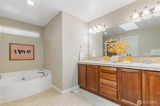 27677 256th Pl SE, Maple Valley, WA 98038 - bathroom with a skylight, double vanity, baseboards, and a bath