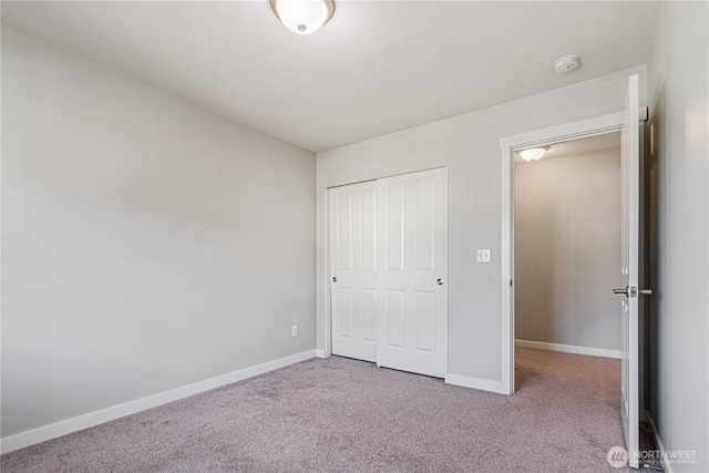 27677 256th Pl SE, Maple Valley, WA 98038 - unfurnished bedroom with carpet flooring, baseboards, and a closet