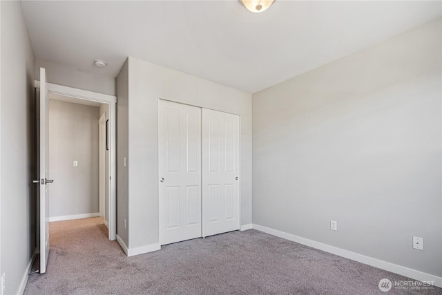 27677 256th Pl SE, Maple Valley, WA 98038 - unfurnished bedroom with carpet floors, baseboards, and a closet