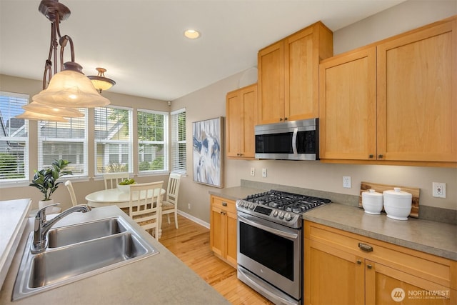 19475 Cherry Blossom Loop NE, Poulsbo, WA 98370 - kitchen featuring stainless steel appliances, a sink, light wood-style floors, recessed lighting, and baseboards