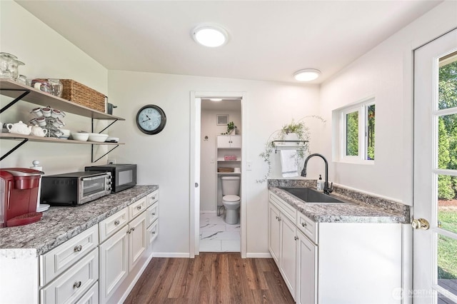 5110 Regan Rd, Cashmere, WA 98815 - kitchen featuring a sink, white cabinets, baseboards, open shelves, and plenty of natural light