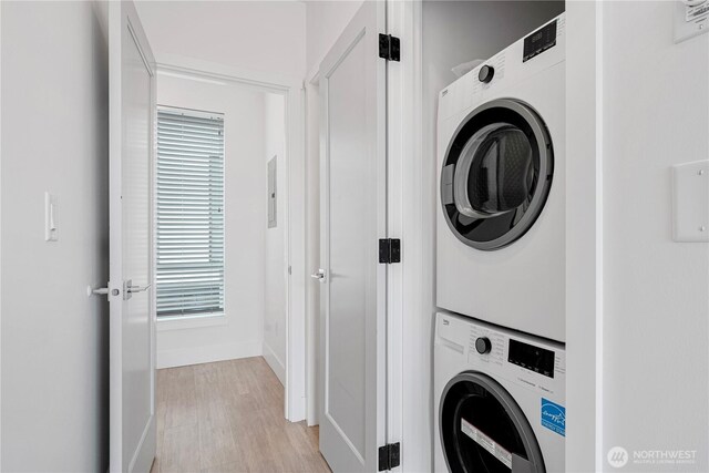 1300 E Remington Ct Unit B, Seattle, WA 98122 - laundry room with estacked washer and dryer, light wood finished floors, and electric panel