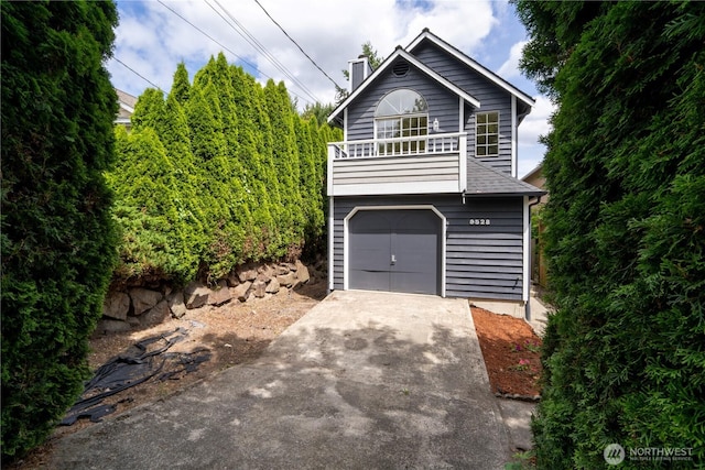 9528 Densmore Ave N, Seattle, WA 98103 - view of front facade featuring concrete driveway, a chimney, and a balcony
