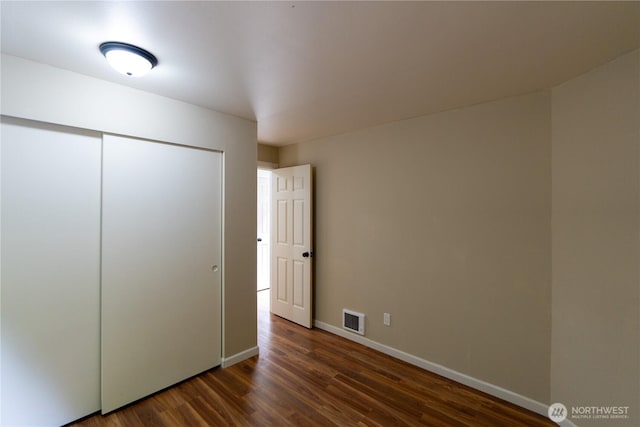 9528 Densmore Ave N, Seattle, WA 98103 - unfurnished bedroom with dark wood-type flooring and a closet