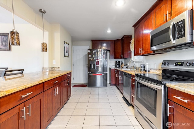 15819 42nd Ave S, Tukwila, WA 98188 - kitchen with appliances with stainless steel finishes, light tile patterned flooring, a sink, light stone counters, and decorative light fixtures