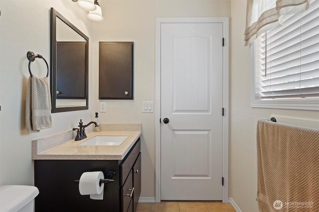 7690 Mcdougall Ave NE, Moses Lake, WA 98837 - half bathroom with vanity, toilet, baseboards, and tile patterned floors