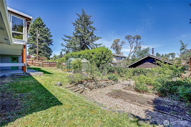 434 T St, Port Townsend, WA 98368 - view of yard with a greenhouse, a garden, and an outbuilding