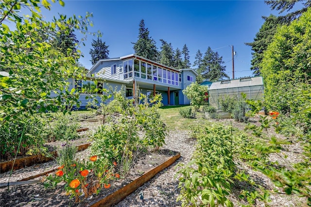 434 T St, Port Townsend, WA 98368 - back of property featuring a garden, an exterior structure, an outbuilding, and a wooden deck