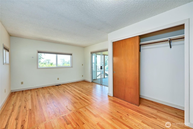 434 T St, Port Townsend, WA 98368 - unfurnished bedroom with wood finished floors, a textured ceiling, and baseboards