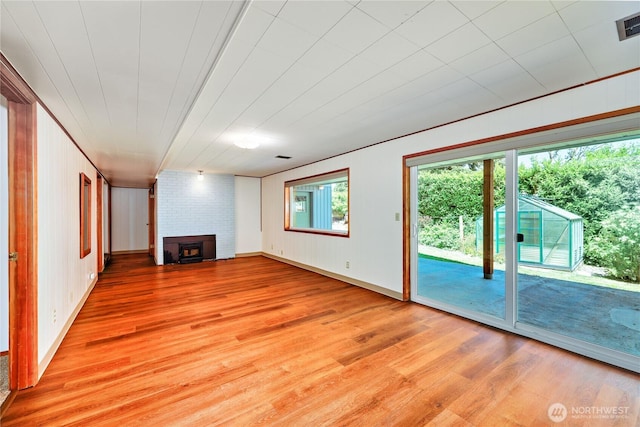 434 T St, Port Townsend, WA 98368 - unfurnished living room featuring light wood-style flooring and a fireplace