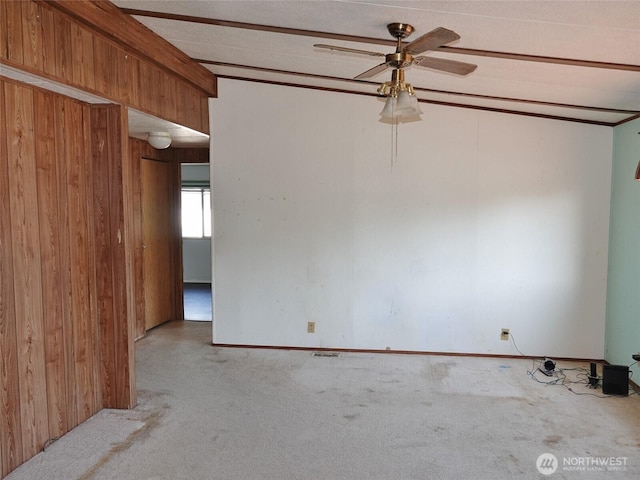 676 Copalis Ave NE, Ocean Shores, WA 98569 - carpeted empty room featuring wood walls and ceiling fan