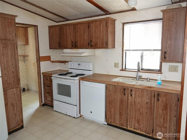 676 Copalis Ave NE, Ocean Shores, WA 98569 - kitchen with white appliances, under cabinet range hood, a sink, light floors, and brown cabinets