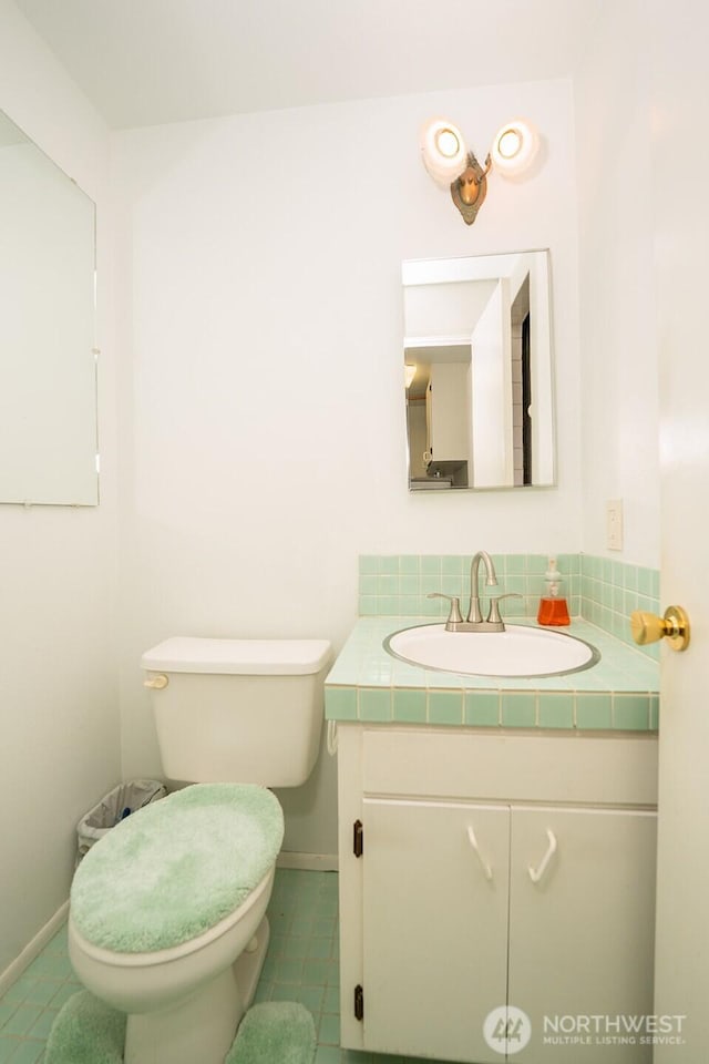 10930 38th Dr SE, Everett, WA 98208 - bathroom with vanity, tile patterned floors, toilet, baseboards, and decorative backsplash