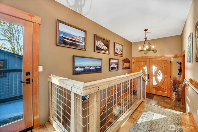 76 Thompson Point Rd, Port Angeles, WA 98363 - entrance foyer featuring a chandelier, wood finished floors, and plenty of natural light