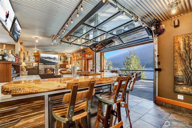 76 Thompson Point Rd, Port Angeles, WA 98363 - bar area with baseboards, track lighting, and a stone fireplace