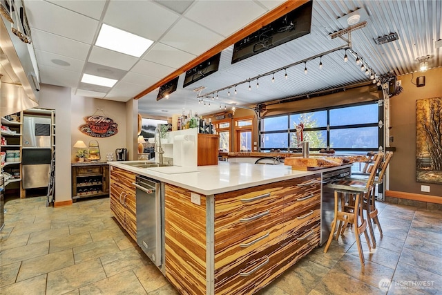 76 Thompson Point Rd, Port Angeles, WA 98363 - kitchen with baseboards, brown cabinets, and light stone finish flooring