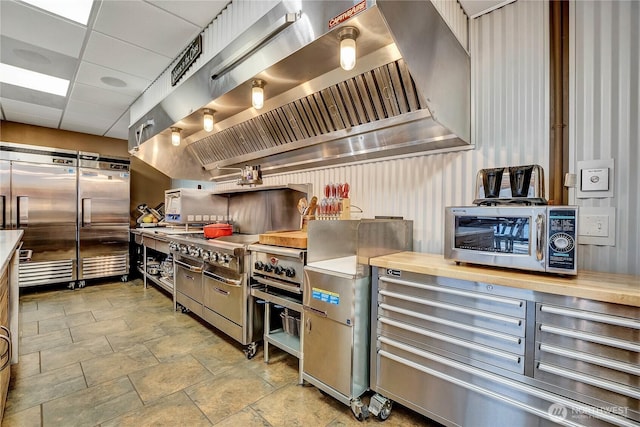 76 Thompson Point Rd, Port Angeles, WA 98363 - kitchen featuring wall chimney range hood and stainless steel appliances