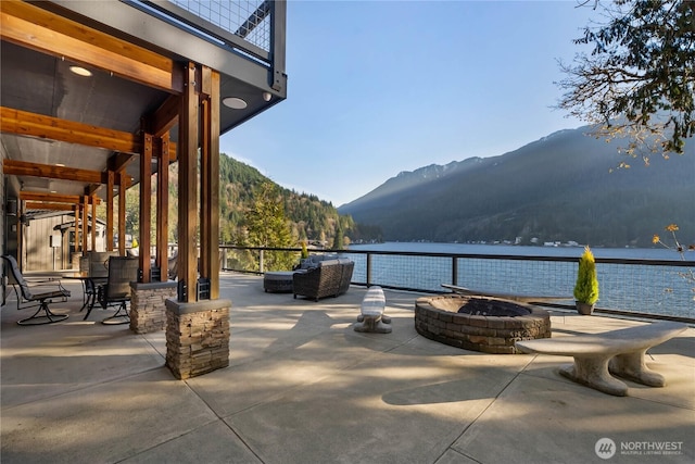 76 Thompson Point Rd, Port Angeles, WA 98363 - view of patio / terrace with a fire pit and a water and mountain view