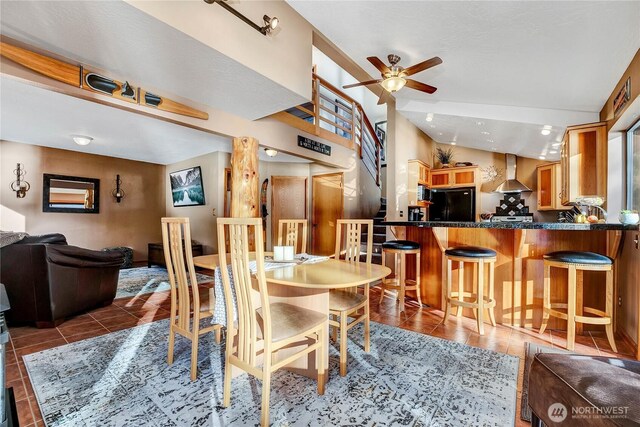 76 Thompson Point Rd, Port Angeles, WA 98363 - dining area with ceiling fan, vaulted ceiling, and tile patterned flooring